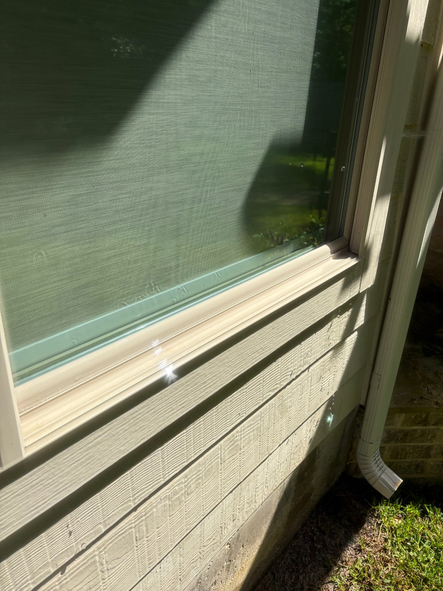 Window with water drops and freshly washed trim and siding — Integrative Services, Montgomery TX