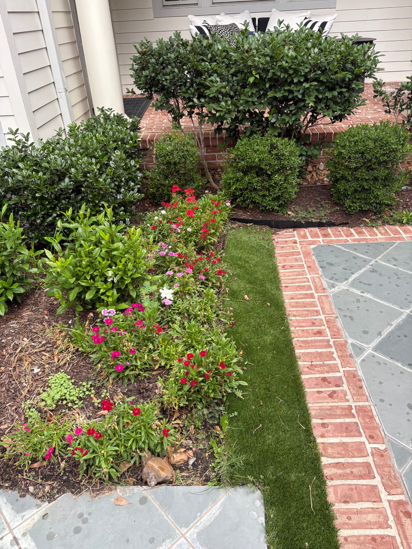 Garden beds and brick walkway beside a home entrance — Integrative Services, Montgomery TX
