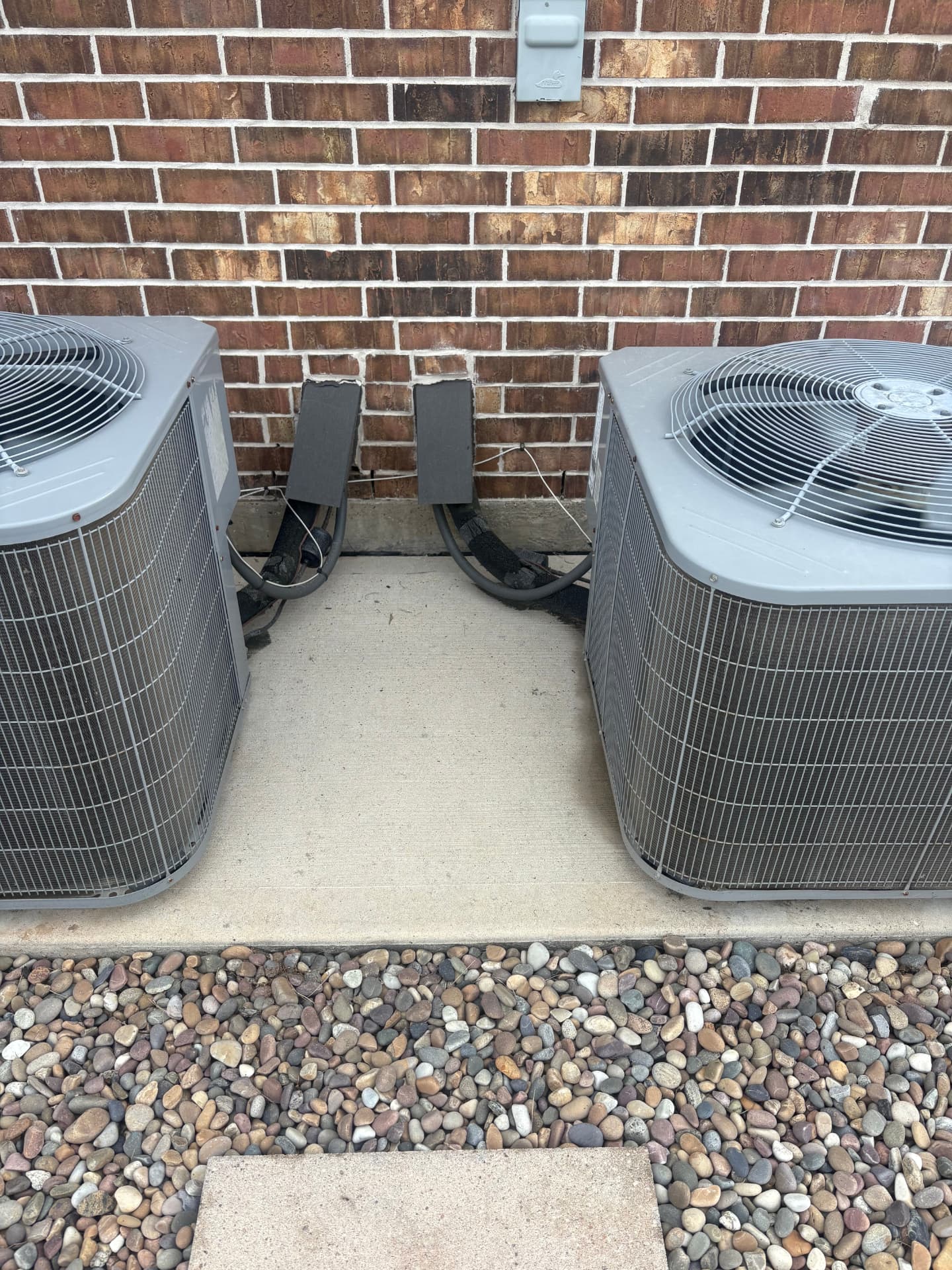 Clean concrete around two air conditioning units — pressure washing in Montgomery, TX